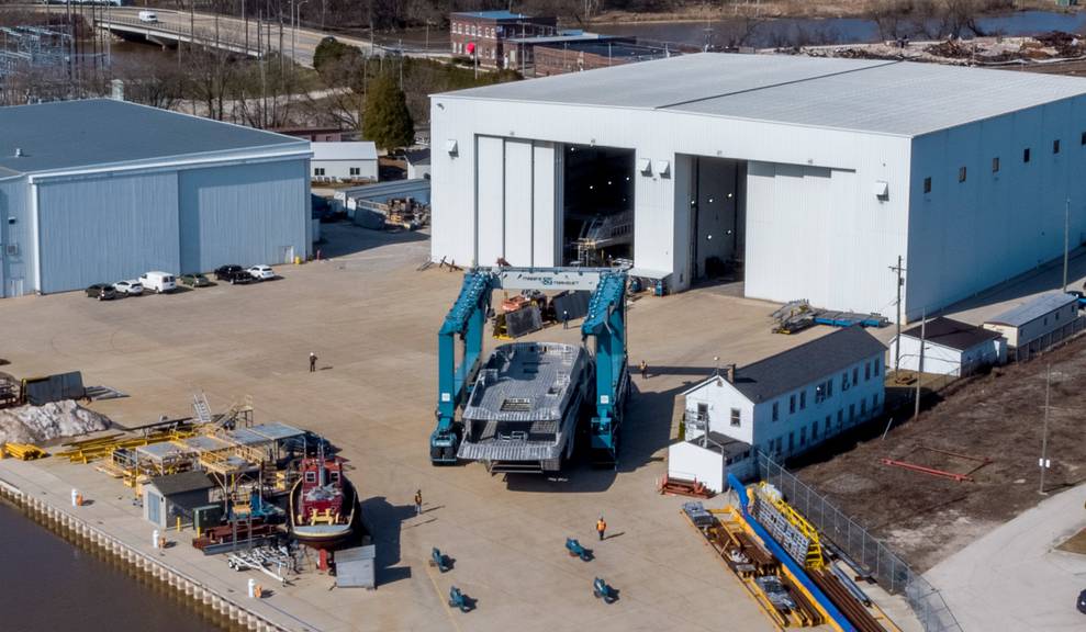 Aerial view of house module being moved by travelift