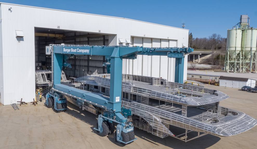 Aerial view of house module being moved by travelift