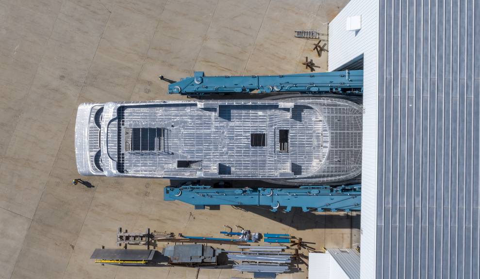 Aerial view of house module being moved by travelift