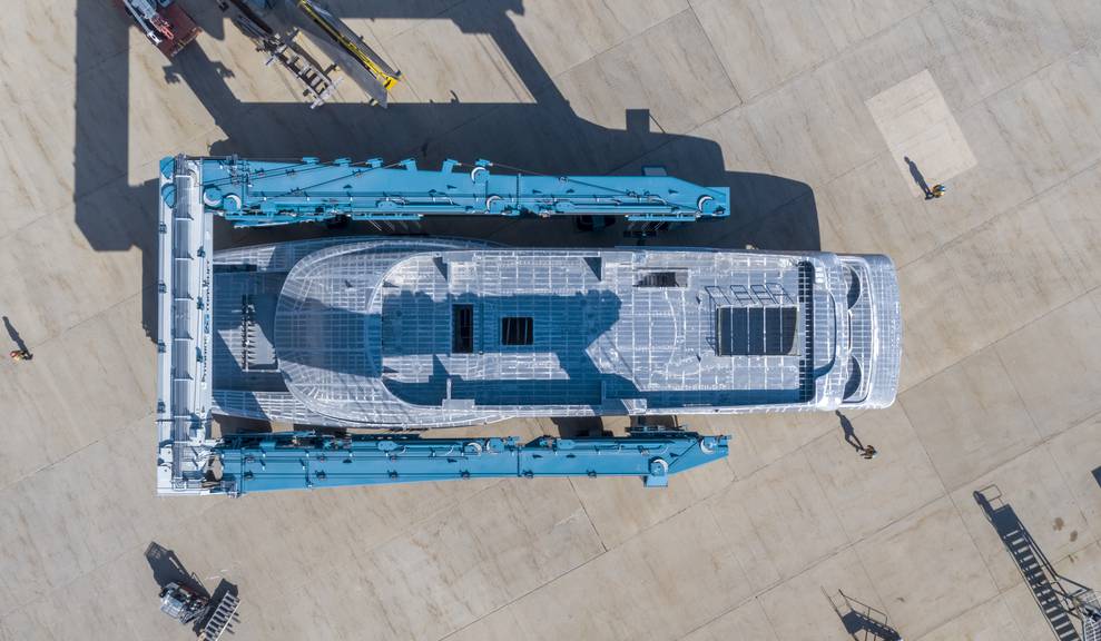 Aerial view of house module being moved by travelift