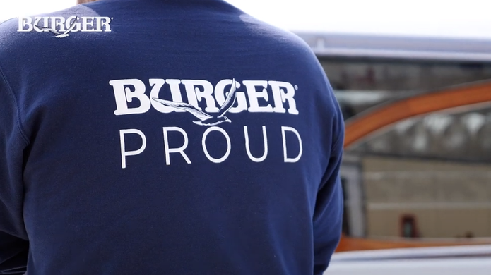 View of back of shirt that a Burger associate is wearing. The shirt says "Burger Proud"