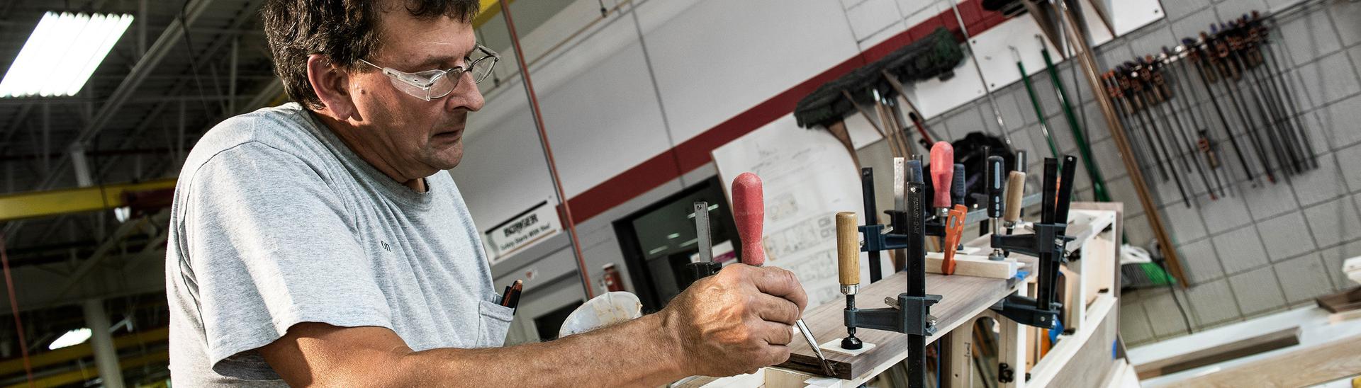 Man working on detail piece of yacht