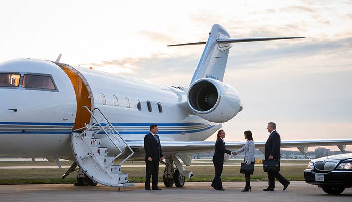 people exiting plane on runway and meeting others
